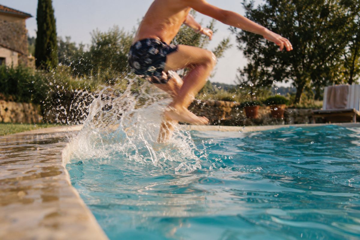 A child jumping into a pool